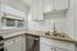 Bright and modern kitchen with sleek countertops, stainless steel sink, and elegant cabinetry, offering a stylish and functional space.