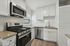 Modern kitchen with sleek stainless steel appliances, granite countertops, and white cabinetry, offering a bright and inviting cooking space.