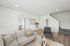Bright and welcoming living room featuring a contemporary design with comfortable seating, a stylish coffee table, and elegant decor.