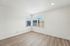 Bright and airy room featuring sleek wooden flooring and large corner windows, perfect for natural light and a cozy atmosphere.