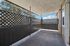 Bright and spacious apartment patio with elegant lattice fencing, offering a peaceful outdoor retreat with scenic views.