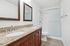 Elegant bathroom with a luxurious dual-sink granite countertop and modern walk-in shower.
