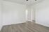 Bright, airy room with sleek laminate flooring and minimalist design, perfect for personalization.