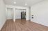 Modern apartment interior featuring sleek wooden floors and an open kitchen layout, perfect for contemporary living.