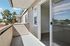 Bright balcony with modern sliding doors offering a scenic view and outdoor relaxation space.