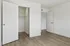 Bright and airy bedroom with elegant hardwood flooring and a spacious closet, perfect for modern living.