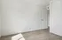 Bright minimalist room with sleek hardwood floors and an open door, ideal for creating a personalized space.