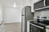 Modern kitchen with stainless steel appliances, sleek granite countertops, and elegant white cabinetry.