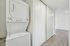 Contemporary apartment with in-unit stackable washer and dryer, sleek wood flooring, and ample closet space.
