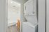 Chic apartment feature showcasing an in-unit washer and dryer beside a sleek, modern bathroom.