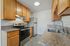 Modern kitchen with sleek stainless steel appliances, elegant granite countertops, and warm wooden cabinetry, perfect for culinary enthusiasts.