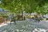 Charming courtyard with lush greenery, outdoor seating, and a welcoming atmosphere for relaxation.