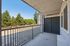 Charming balcony view offering a serene outlook with lush greenery and modern railing design.