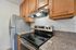 Contemporary kitchen featuring modern stainless steel appliances, sleek countertops, and elegant wooden cabinetry, perfect for culinary enthusiasts.