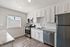 Bright kitchen with modern stainless steel appliances, sleek granite countertops, and elegant white cabinetry.