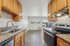 Bright kitchen with sleek granite countertops, modern appliances, and natural wood cabinets offering a welcoming atmosphere.