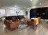 Elegant lounge area with modern lighting, cozy leather seating, and stylish decor, creating a welcoming ambiance.