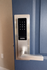 Sleek digital door lock with touchscreen keypad on a modern blue entrance, offering advanced security and style.