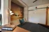 Cozy bedroom with ambient lighting, stylish decor, and a serene sunset mural for a tranquil atmosphere.