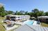 Charming apartment complex with a refreshing outdoor pool, surrounded by lush greenery and modern amenities.