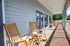 Inviting porch with wooden rocking chairs offering a serene setting for relaxation and enjoying the outdoors.