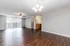 Bright, open-concept living space featuring elegant wooden flooring, modern lighting, and large windows with a scenic view.
