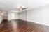 Expansive open-plan living area with elegant wooden flooring and neutral walls, highlighted by a stylish ceiling fan.