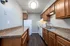 Modern kitchen with sleek granite countertops, wood cabinetry, and stainless steel sink under soft ambient lighting.