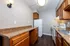 Charming kitchen with elegant wooden cabinets, sleek granite countertops, and modern appliances, offering a cozy and functional cooking space.