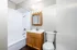 Modern bathroom with sleek white bathtub, elegant vanity, and stylish mirror, exuding a clean and inviting atmosphere.