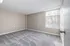 Bright and inviting empty room with plush new carpet, neutral walls, and a large window allowing ample natural light.