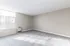 Bright and spacious room with large windows and cozy carpet flooring, perfect for comfortable living.