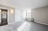 Bright and inviting room with plush carpeting, large window for natural light, and a spacious closet; perfect for comfortable living.