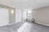 Bright and spacious room with soft carpeting, large window, and modern accent lighting, ideal for comfort and style.