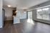 Bright and luxurious open floor plan apartment with sleek wood flooring, modern kitchen, and expansive windows for natural light.