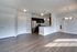 Modern open-concept apartment featuring sleek hardwood floors, an elegant kitchen with stainless steel appliances, and abundant natural light.