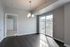 Bright dining area with elegant pendant lighting and sliding glass doors opening to a scenic balcony view.