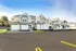 Charming row of modern two-story townhomes with spacious garages and well-maintained landscaping.