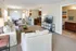 Inviting open-concept living space featuring cozy sofas, a modern kitchen with bar seating, and a stylish dining area, perfect for entertaining.