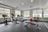 Modern fitness center featuring state-of-the-art equipment, abundant natural light, and a sleek design.