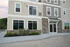 Charming modern apartment exterior with elegant stone and siding facade, large windows, and inviting entryway.