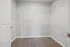 Spacious walk-in closet featuring white wire shelving and plush carpeting, perfect for organizing your wardrobe.
