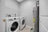 Modern utility room showcasing energy-efficient washer, dryer, and hot water heater, perfect for a hassle-free lifestyle.