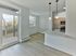 Bright apartment kitchen with breakfast bar, balcony access, and wood-style floors at Crestwood Apartments in Wayne, PA