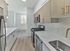 Renovated galley kitchen with stainless steel appliances and modern finishes at Crestwood Apartments in Wayne, PA