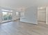 Open living and dining space with wide plank flooring and private balcony at Crestwood Apartments in Wayne, PA