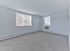 Spacious carpeted bedroom with large windows and natural light at Crestwood Apartments in Wayne, PA