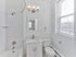 Renovated bathroom with white vanity, modern lighting, and natural light at Crestwood Apartments in Wayne, PA