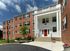 Main entrance of Crestwood Apartments with red door and colonial-style architecture in Wayne, PA