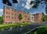 Wide view of Crestwood Apartments featuring manicured landscaping and colonial-style entry in Wayne, PA